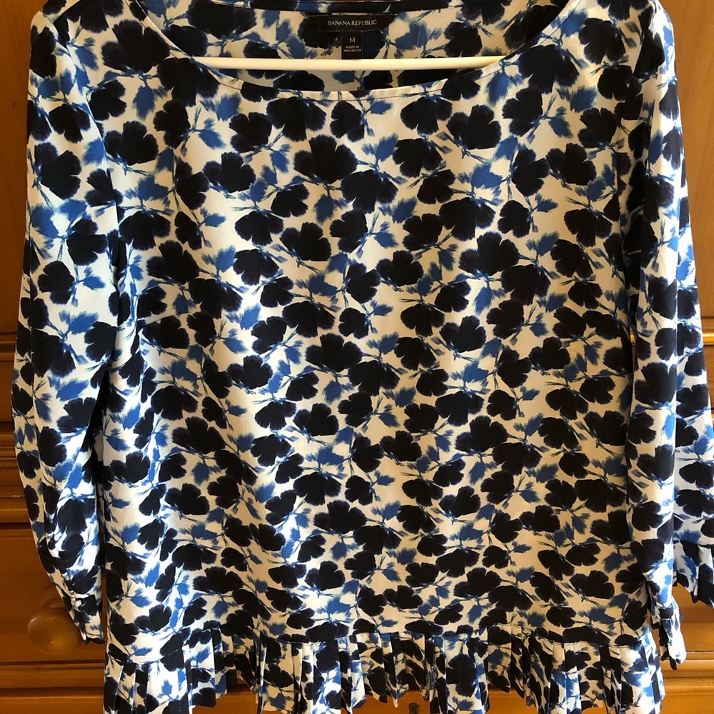 Blue/White Print Top with Ruffle Hem.